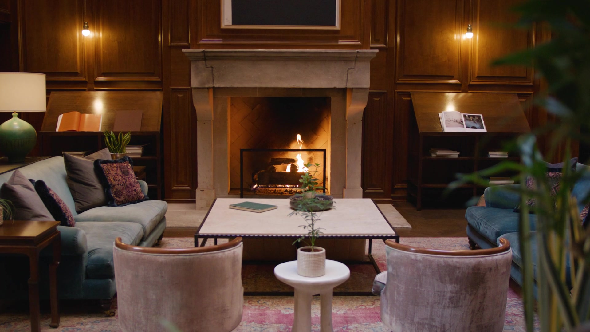 Fireplace and seating in the wood-paneled interior of The Adolphus Hotel