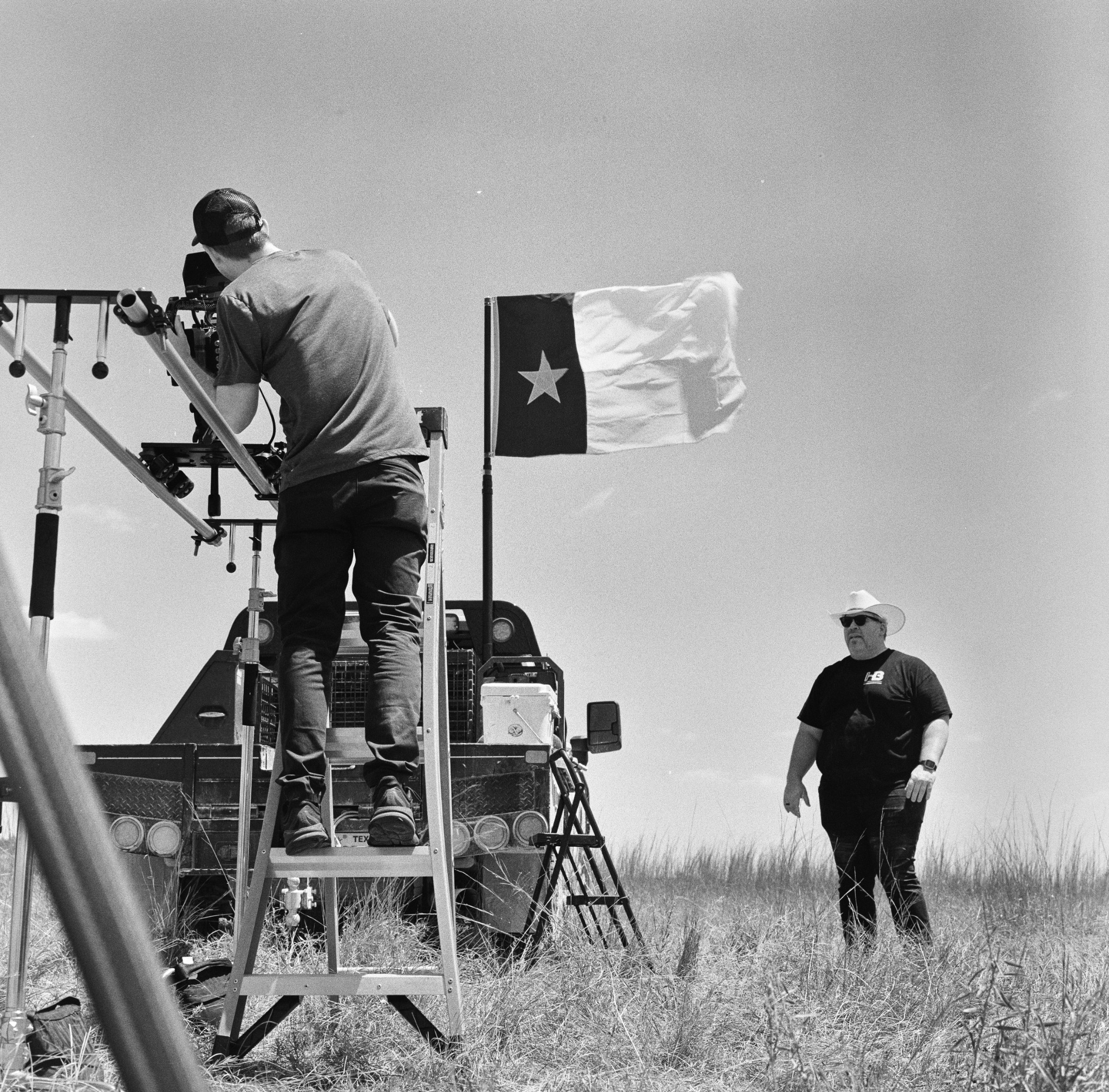 Paul Malm operating the camera on the All Cattle, No Hat shoot, photographed in black and white